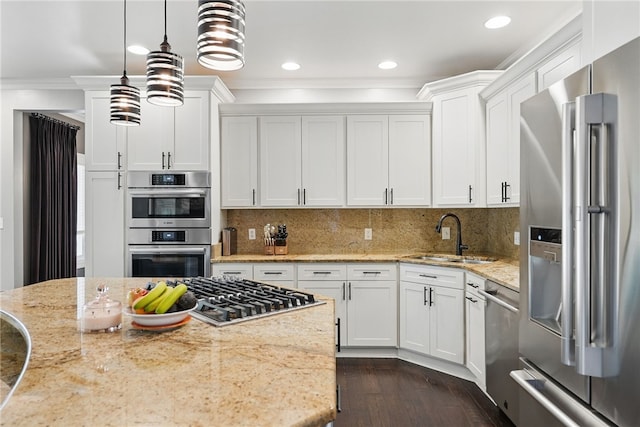 104 Ross Creek Ln, Peters Twp, PA 15367 - kitchen featuring appliances with stainless steel finishes, a sink, crown molding, white cabinetry, and decorative light fixtures