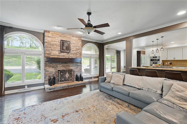 104 Ross Creek Ln, Peters Twp, PA 15367 - living room with crown molding, wood-type flooring, a ceiling fan, a stone fireplace, and recessed lighting