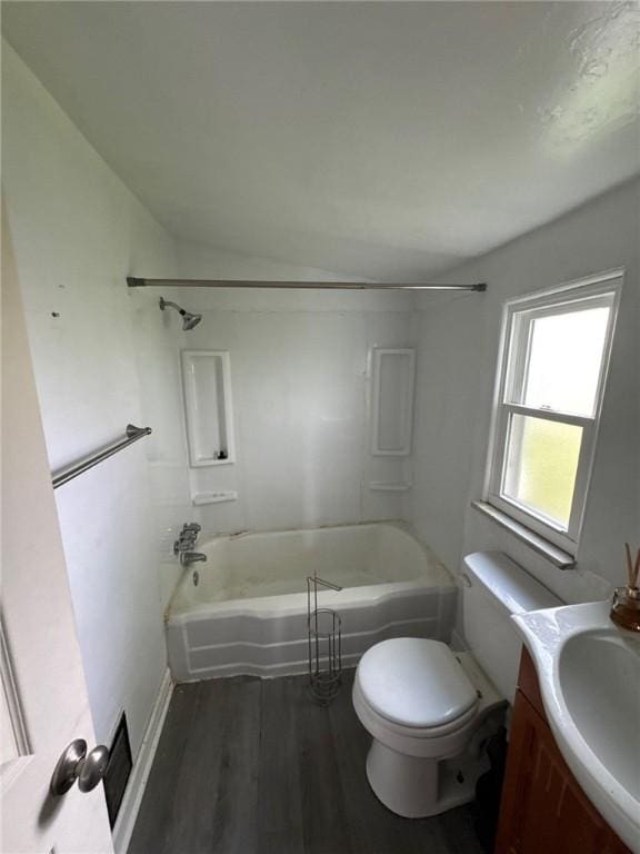full bath featuring wood finished floors,  shower combination, toilet, vanity, and baseboards