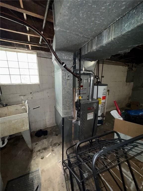 utility room featuring water heater and a sink