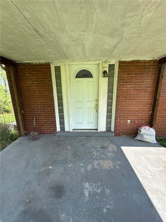 entrance to property with brick siding