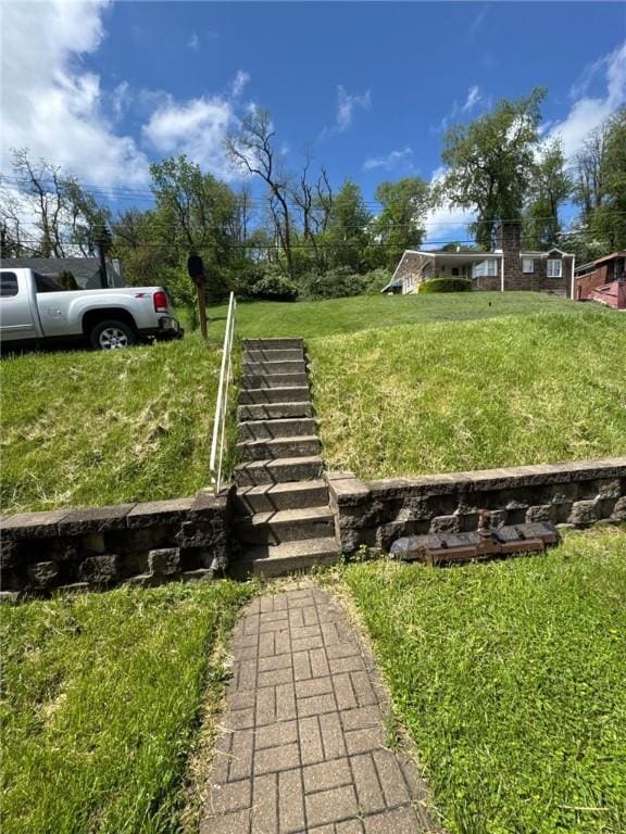 view of community with a lawn and stairs
