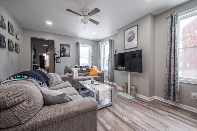 living room featuring wood finished floors, a ceiling fan, baseboards, and recessed lighting