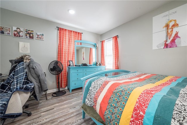 bedroom with light wood finished floors, recessed lighting, and baseboards