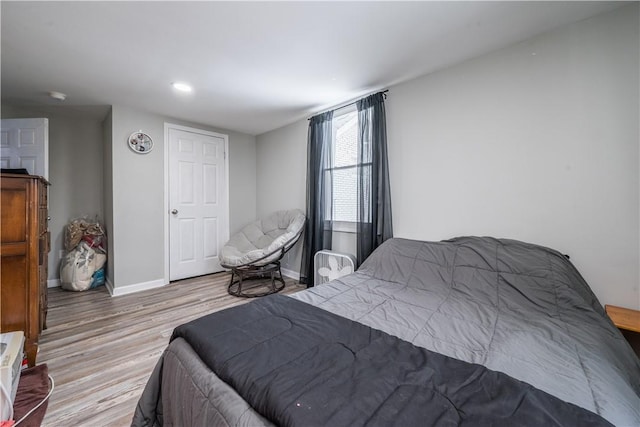 bedroom featuring wood finished floors, baseboards, and recessed lighting