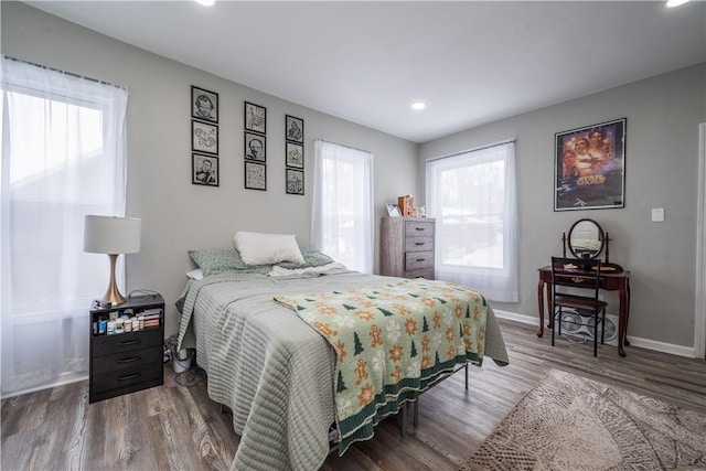bedroom featuring wood finished floors, recessed lighting, and baseboards