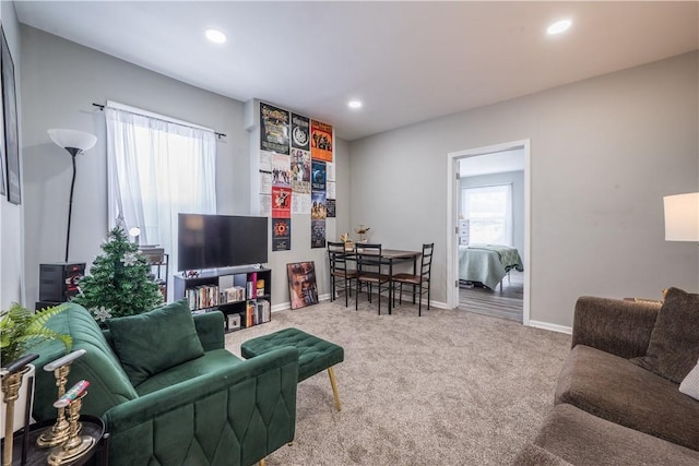 carpeted living area with baseboards and recessed lighting