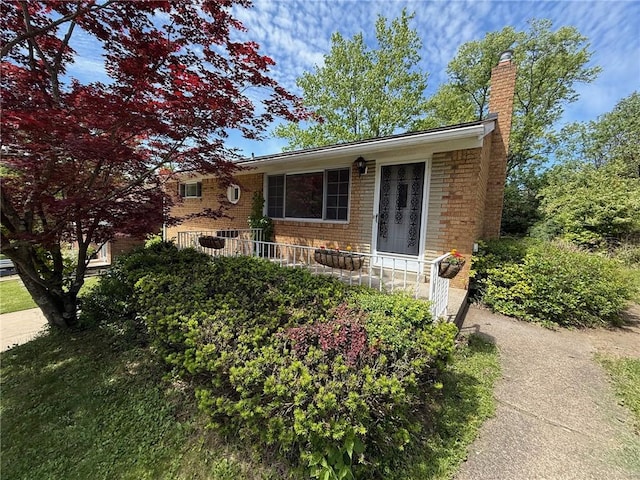 130 Anthon Dr, Penn Hills, PA 15235 - view of front of home featuring brick siding and a chimney