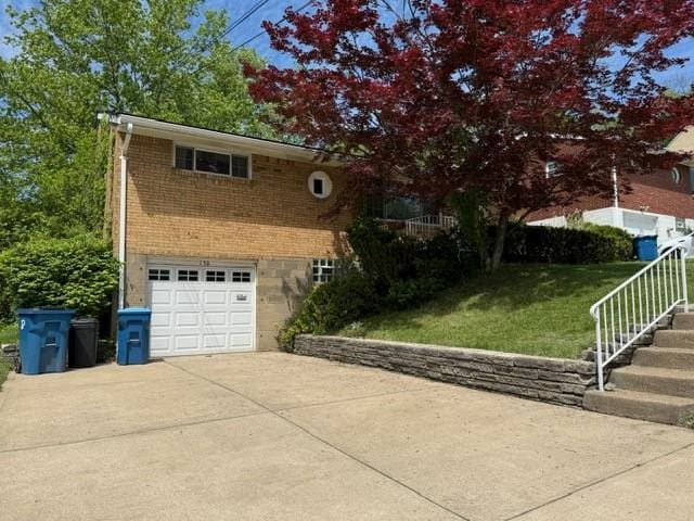130 Anthon Dr, Penn Hills, PA 15235 - view of front of property featuring driveway, brick siding, a front lawn, and an attached garage