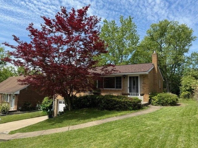 130 Anthon Dr, Penn Hills, PA 15235 - view of front of home with driveway, a front lawn, a chimney, brick siding, and a garage