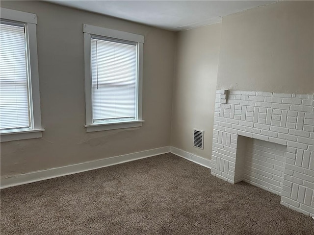 6511 Clifford St, Lincoln-Larimer, PA 15206 - unfurnished living room featuring dark colored carpet, plenty of natural light, and baseboards
