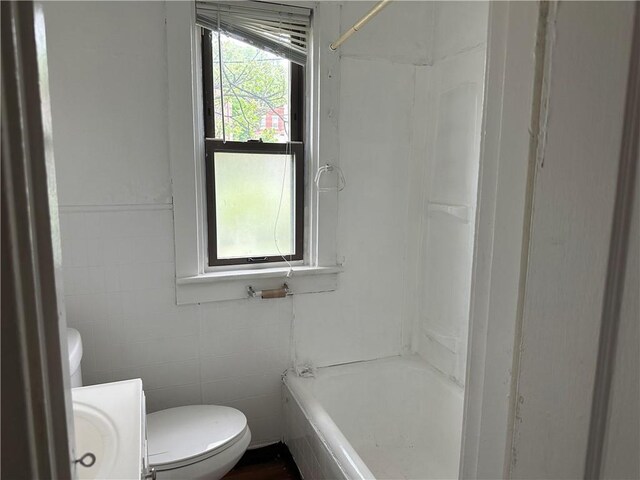 6511 Clifford St, Lincoln-Larimer, PA 15206 - bathroom featuring tile walls, toilet, vanity, and shower / tub combination
