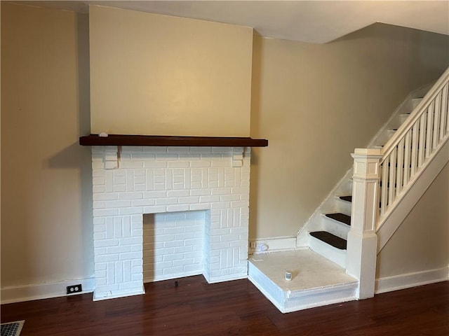 6511 Clifford St, Lincoln-Larimer, PA 15206 - stairway with wood finished floors, baseboards, and a brick fireplace