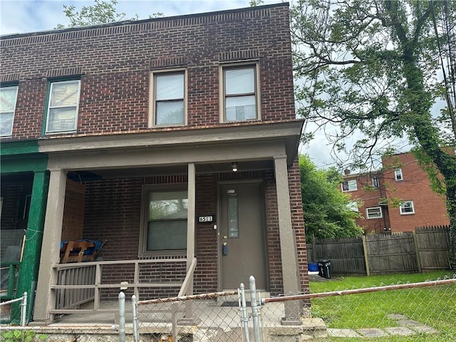 6511 Clifford St, Lincoln-Larimer, PA 15206 - view of front of property with brick siding, a porch, and a fenced front yard