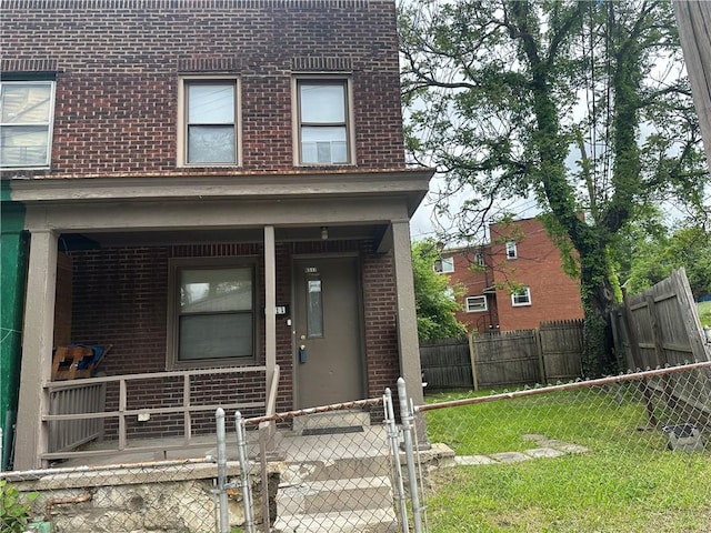 6511 Clifford St, Lincoln-Larimer, PA 15206 - view of exterior entry featuring brick siding, a porch, and a gate