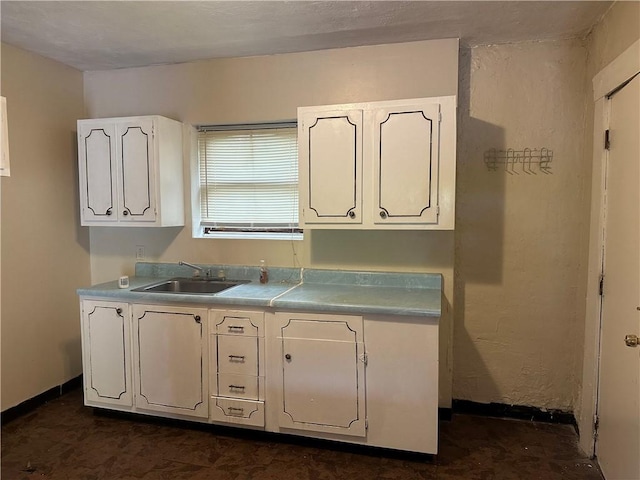 6511 Clifford St, Lincoln-Larimer, PA 15206 - kitchen featuring white cabinetry, a sink, light countertops, and baseboards