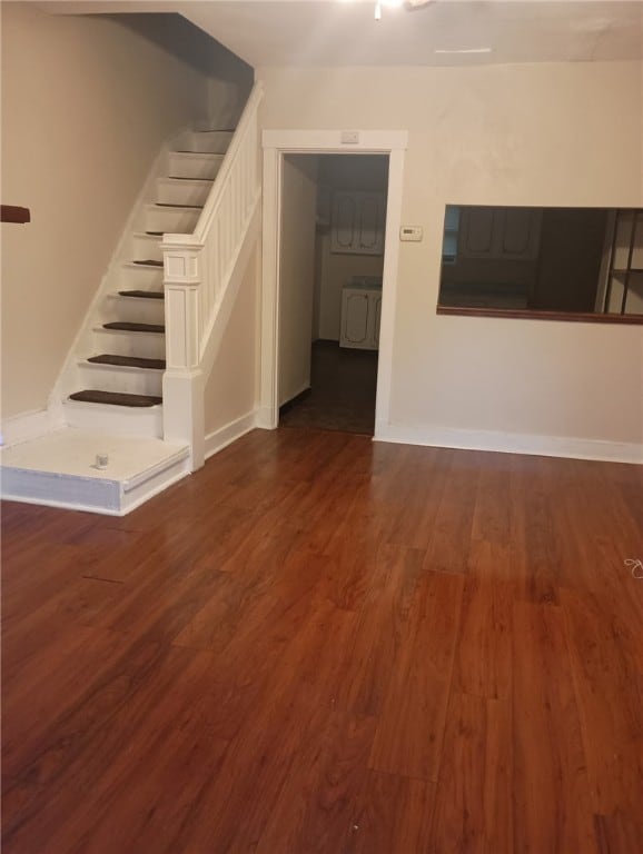 6511 Clifford St, Lincoln-Larimer, PA 15206 - unfurnished living room with stairway, dark wood-type flooring, and baseboards