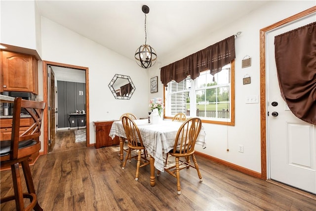dining area with dark wood finished floors, vaulted ceiling, baseboards, and a chandelier