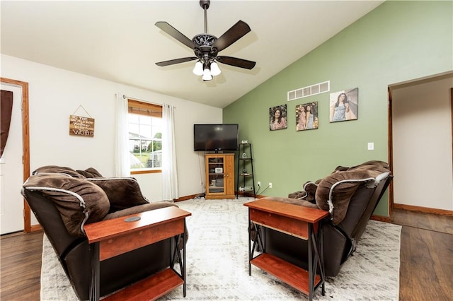 living room featuring lofted ceiling, wood finished floors, a ceiling fan, and baseboards