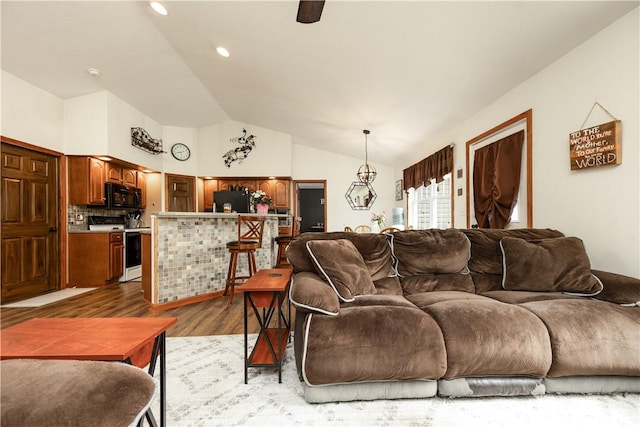 living area featuring light wood-style flooring, lofted ceiling, recessed lighting, and a ceiling fan