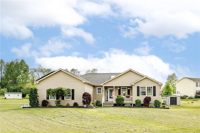 single story home featuring a storage unit, covered porch, an outdoor structure, and a front lawn