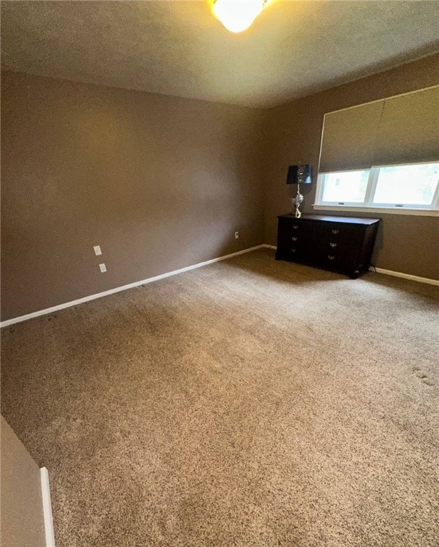 unfurnished bedroom with baseboards and carpet floors