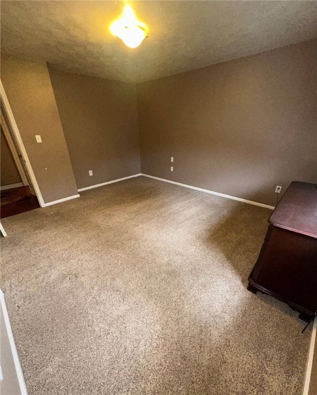 spare room with carpet floors and baseboards
