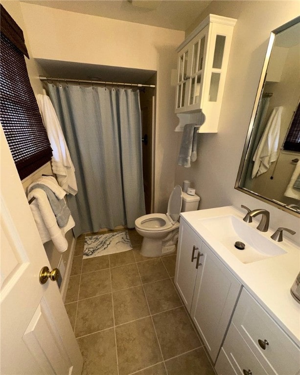 bathroom featuring tile patterned floors, toilet, vanity, and a shower with shower curtain