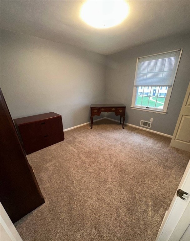 unfurnished bedroom featuring carpet and baseboards