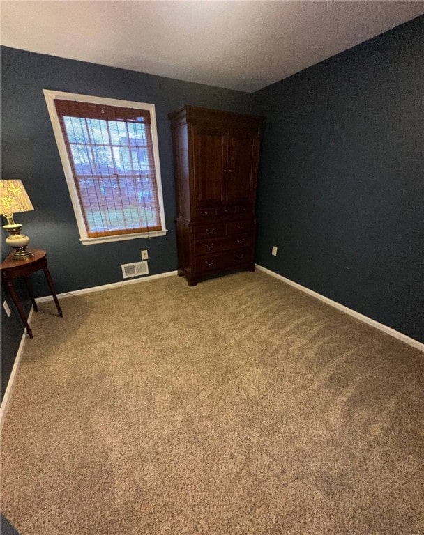 unfurnished bedroom with carpet and baseboards