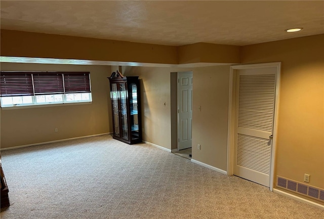 unfurnished bedroom with carpet floors, baseboards, and a closet