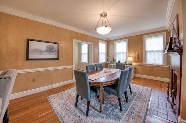 1010 Glenshaw Ave, Shaler, PA 15116 - dining area with wood finished floors, baseboards, ornamental molding, and a fireplace with flush hearth