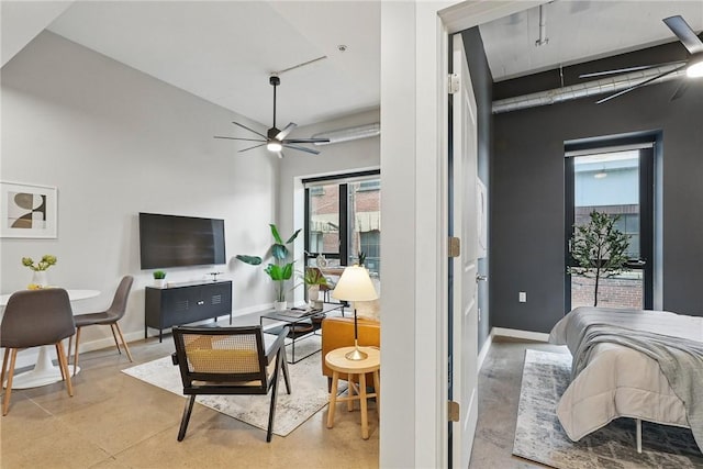 bedroom with baseboards, concrete floors, and a high ceiling