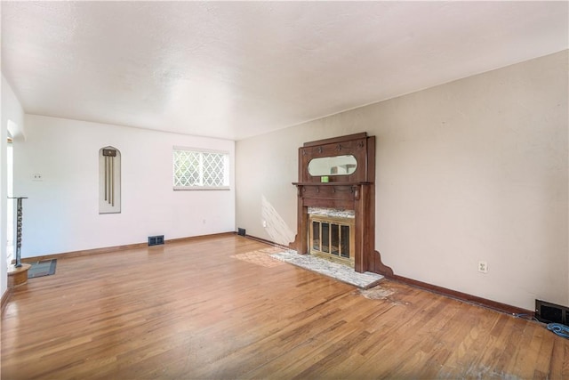 5251 Meadowgreen Dr, Whitehall, PA 15236 - unfurnished living room with a glass covered fireplace, light wood-style floors, and baseboards