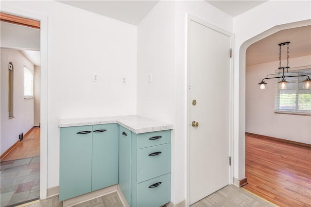 5251 Meadowgreen Dr, Whitehall, PA 15236 - hallway with arched walkways, healthy amount of natural light, light wood finished floors, and baseboards