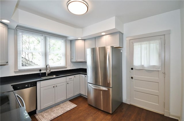 18 W Manilla Ave, Green Tree, PA 15220 - kitchen featuring appliances with stainless steel finishes, a sink, dark countertops, dark wood-type flooring, and recessed lighting