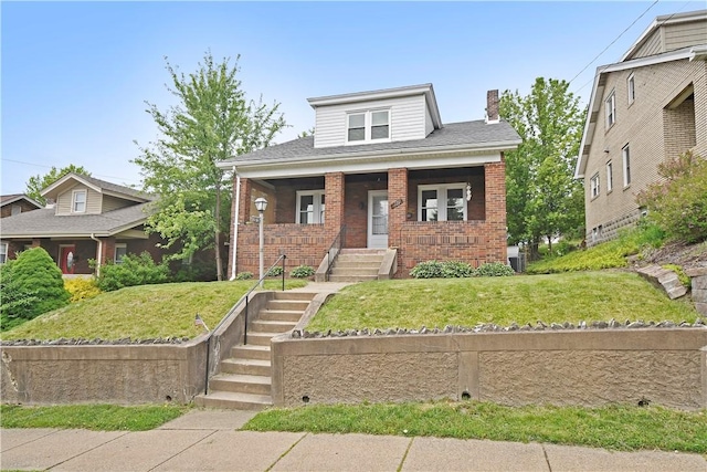 18 W Manilla Ave, Green Tree, PA 15220 - view of front facade featuring brick siding, a chimney, and a front yard