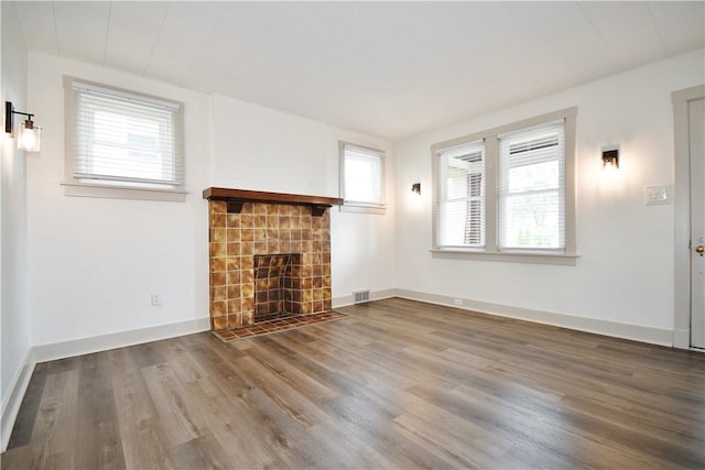 18 W Manilla Ave, Green Tree, PA 15220 - unfurnished living room featuring wood finished floors, a tile fireplace, and baseboards