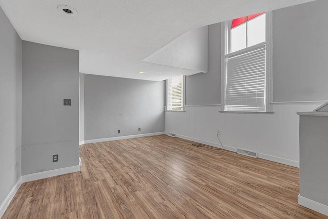 spare room with wood finished floors and baseboards