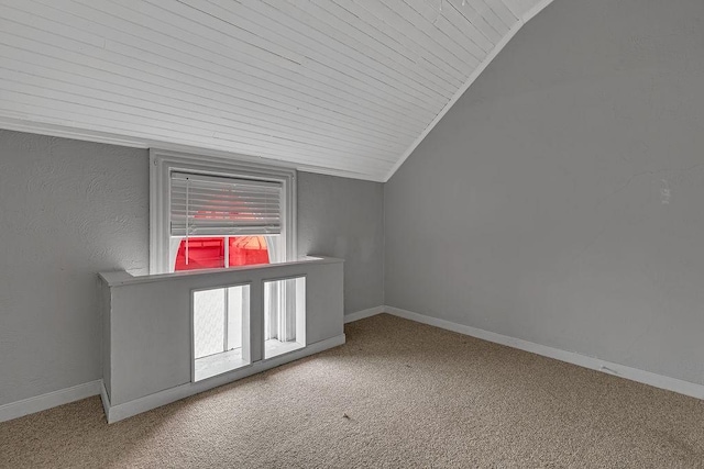 bonus room featuring lofted ceiling, carpet floors, and baseboards