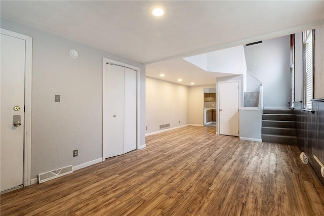 basement featuring wood finished floors, stairway, baseboards, and recessed lighting
