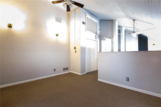 carpeted spare room featuring a ceiling fan and baseboards