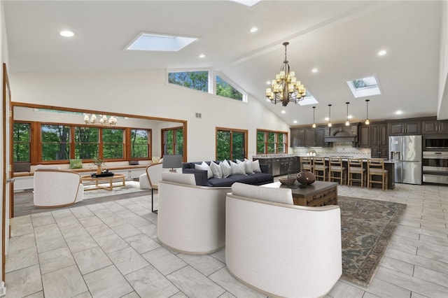 living room featuring a skylight, a chandelier, high vaulted ceiling, and recessed lighting