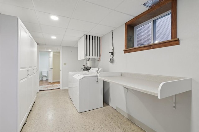 laundry room with washing machine and dryer, recessed lighting, and baseboards