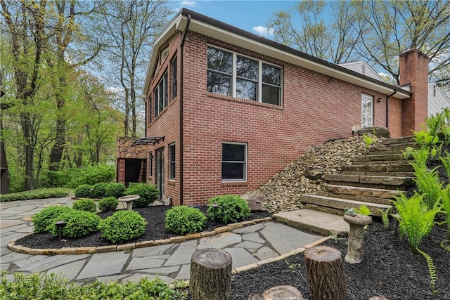 view of side of property featuring brick siding