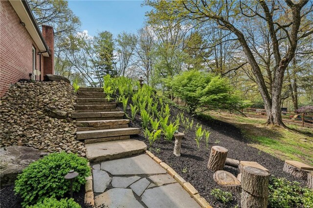 view of yard featuring stairs and fence