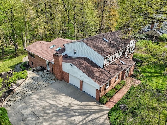 aerial view of property and surrounding area with a forest