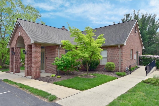 1704 Waterleaf Dr, Franklin Park, PA 15143 - view of front facade with brick siding, a shingled roof, a chimney, and a front lawn