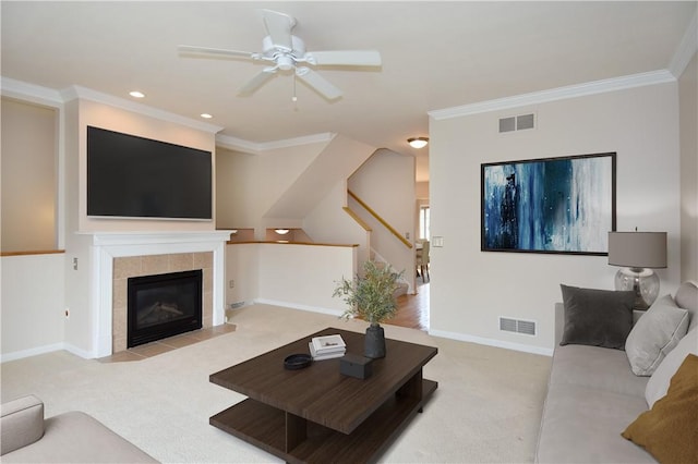 1704 Waterleaf Dr, Franklin Park, PA 15143 - living room featuring carpet, a ceiling fan, crown molding, a tiled fireplace, and stairs