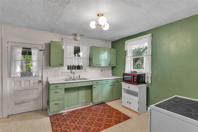 1108 Wills Ave, Lower Burrell, PA 15068 - kitchen with green cabinetry, electric range, a sink, light countertops, and a textured ceiling